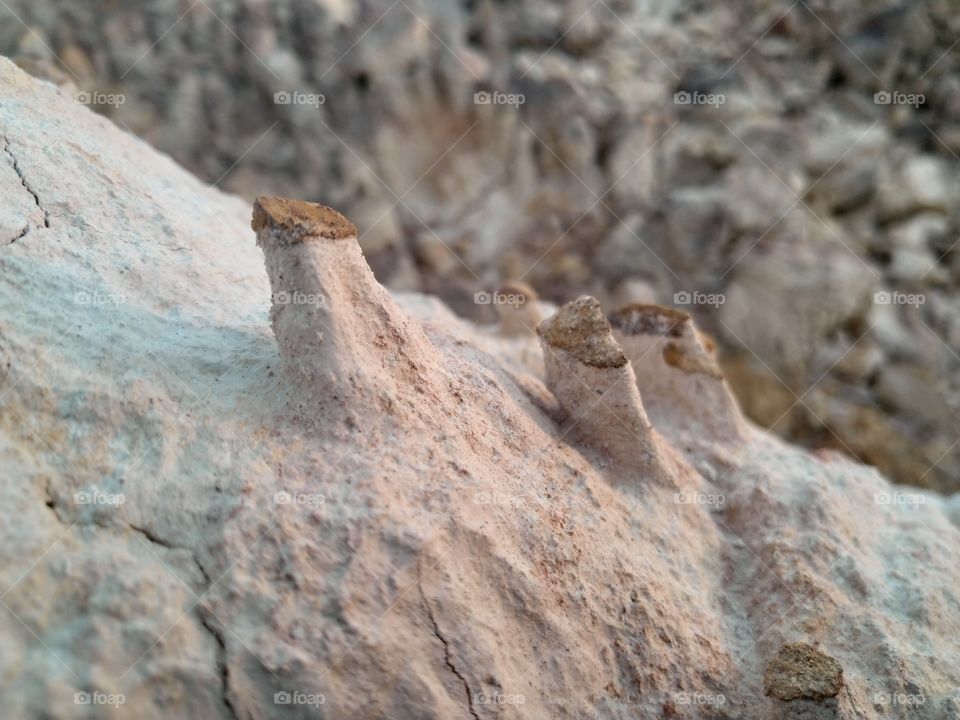 Natural erosion of rock and soil.