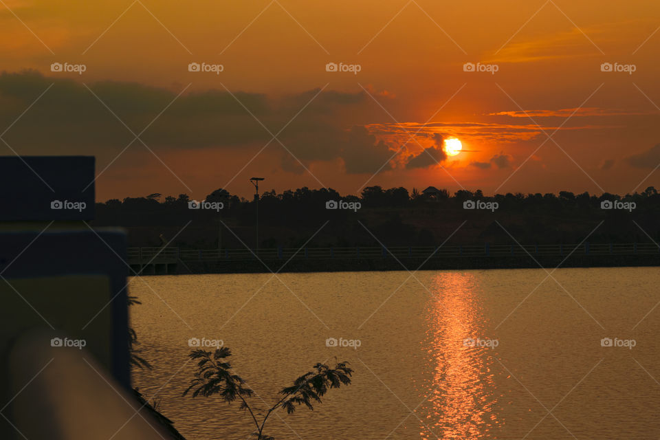 Full sunset at evening side lake