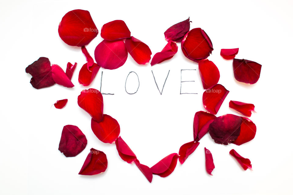 Heart Shaped Red Rose Petals With Love Word Text Message Isolated In White Background
