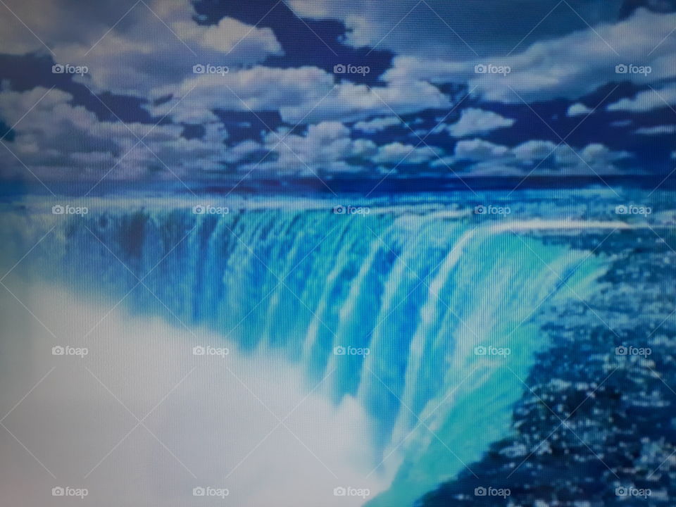 Beautiful waterfall showing the strength of nature with sky full of clouds and blue sky