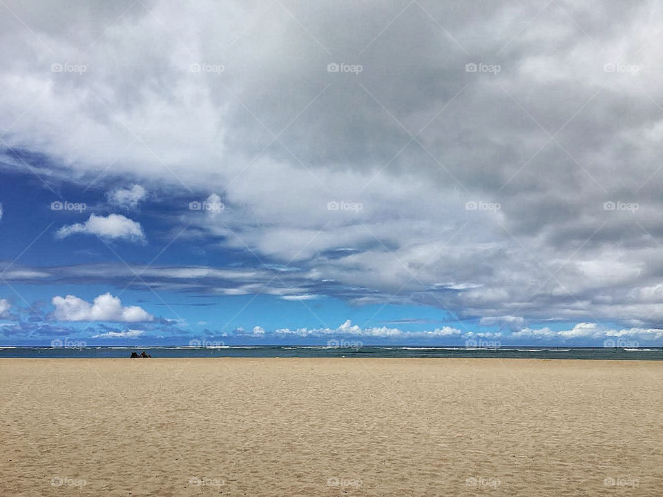 Nearly empty Waikiki beach on a cloudy day