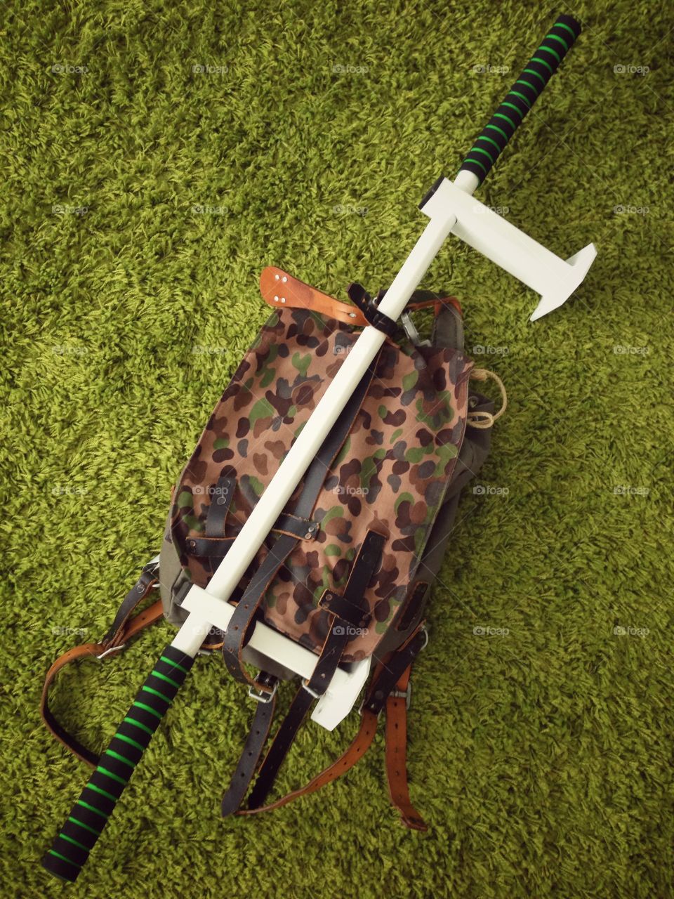 Austrian army backpack with a training horizontal bar on a green carpet