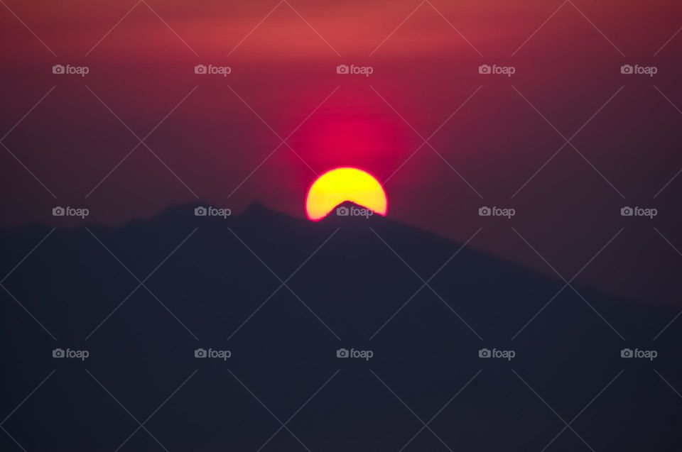 the rising sun appeared to appear from behind the mountain