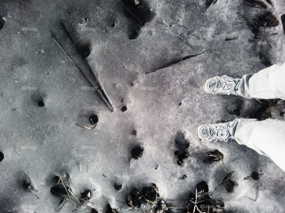 legs shoes on the ice lake shore texture