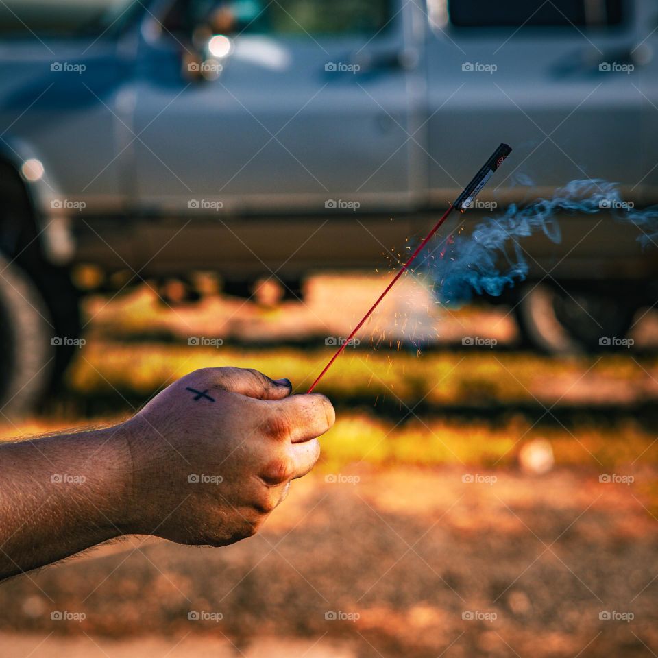 Firework in hand about to take off.