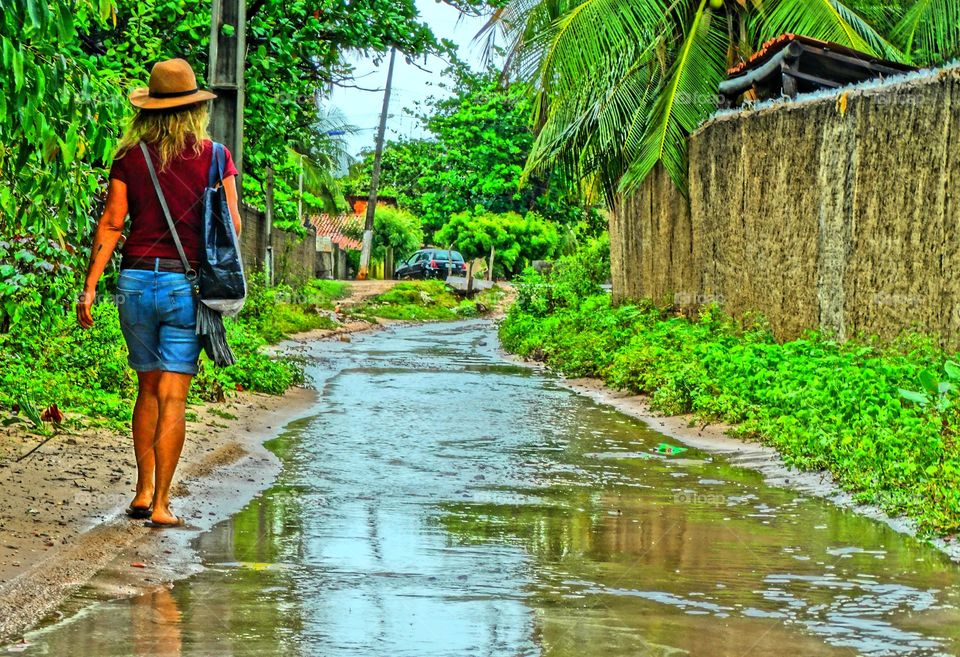 Girl walking in the rain. A girl walking after the rain