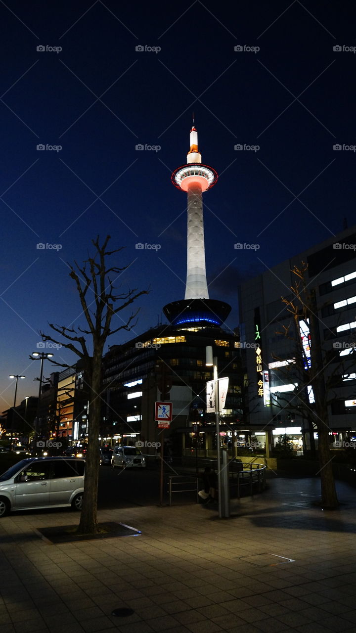 View of Kyoto Tower from Kyoto Station just after dusk.