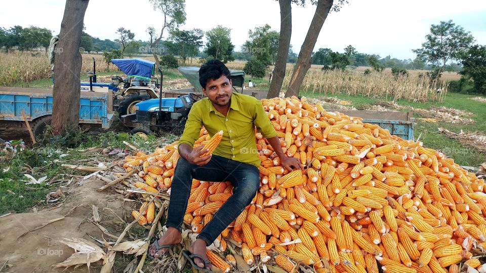 happy farmer with maize