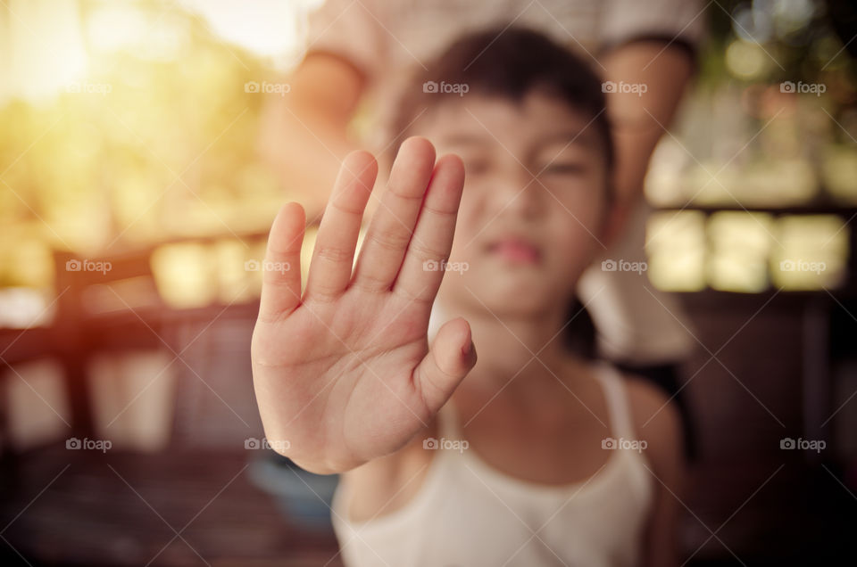 Cute girl showing her palm as a stop signal.