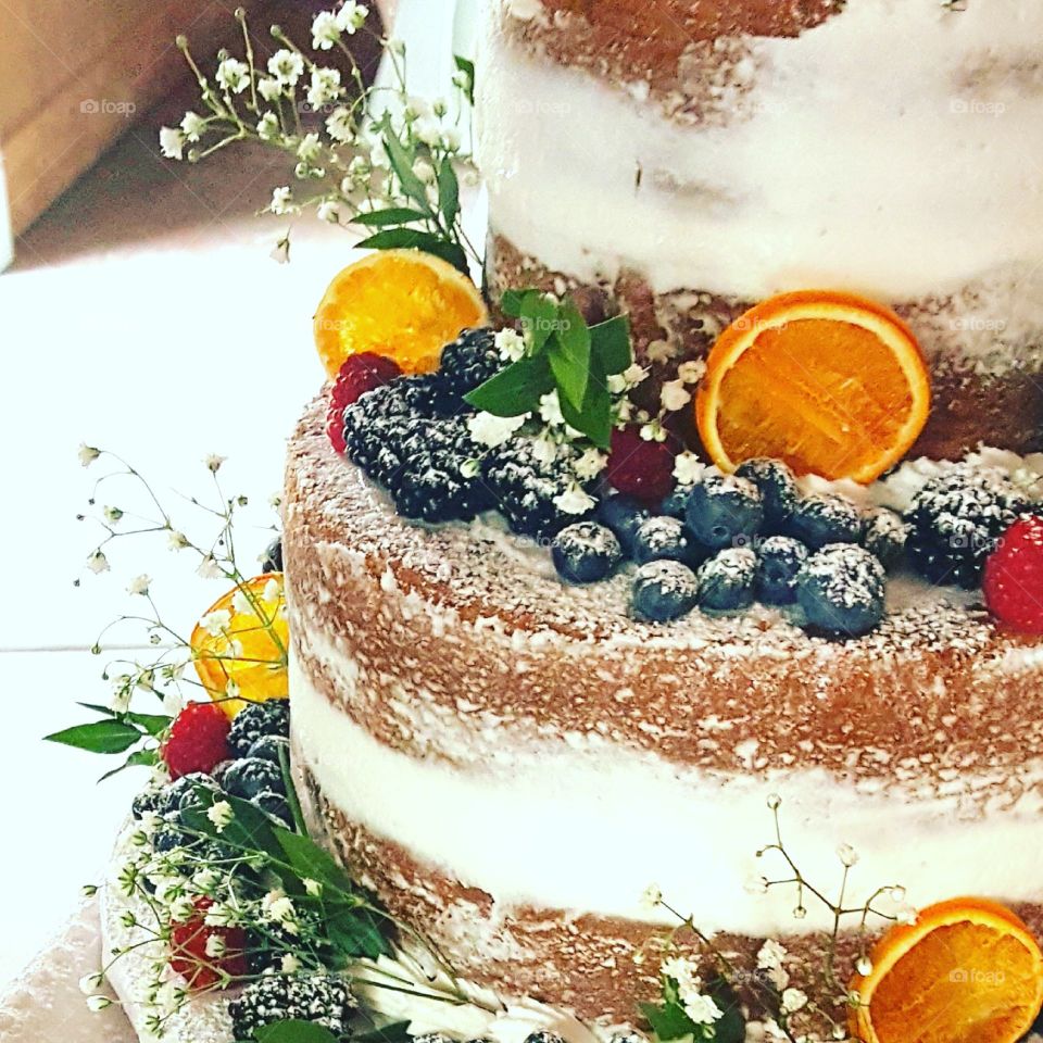 A fruit covered wedding cake tempts guests.