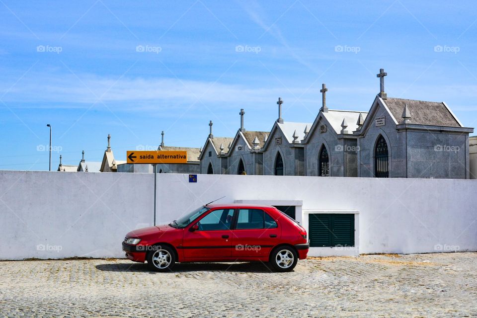 red car near the cemetery