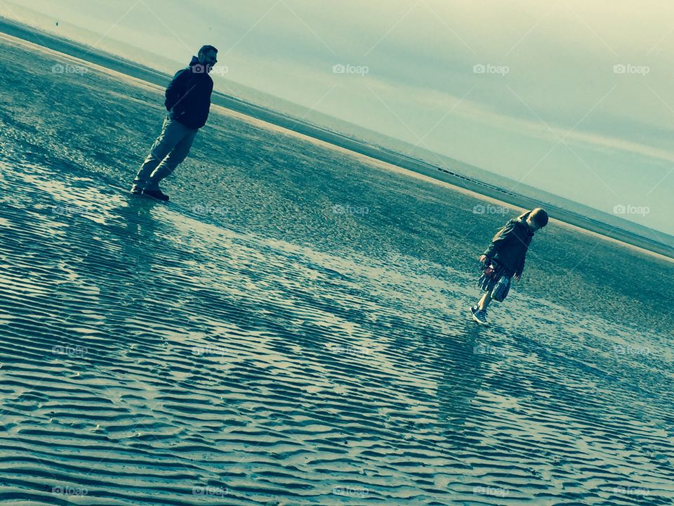 Father and daughter beach walk