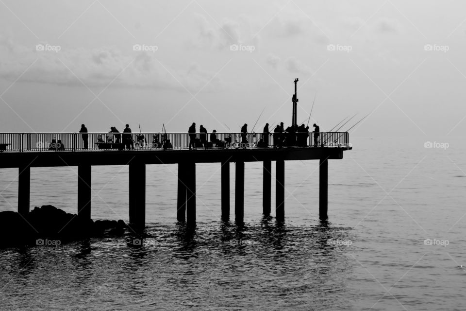 group of fishermen on the pier