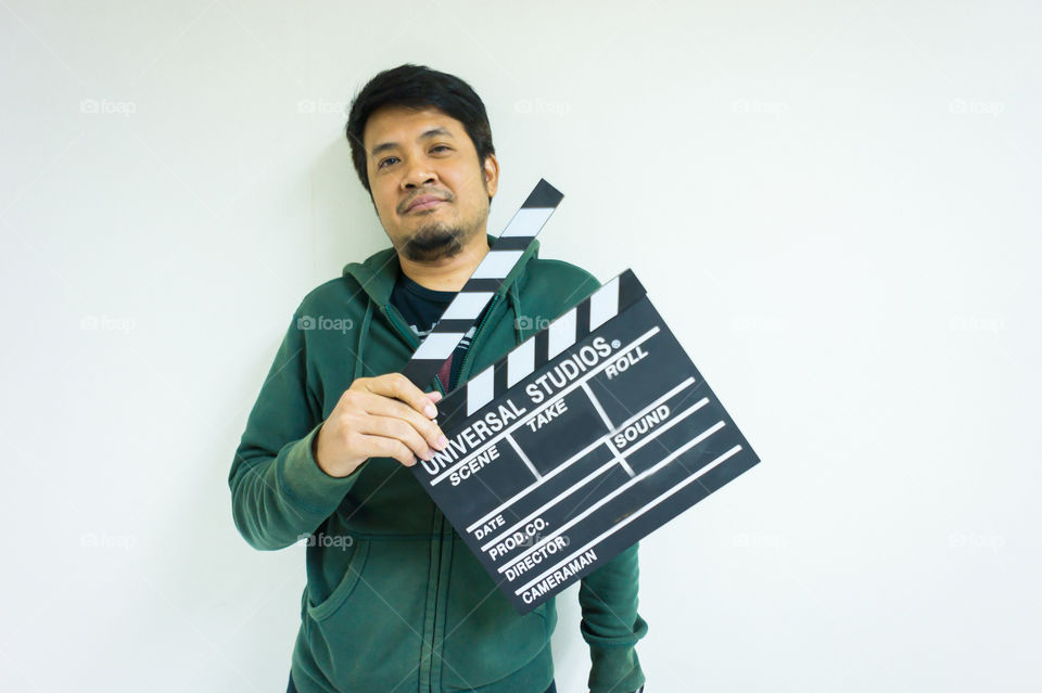Man and clapper board for making video cinema in studio.Movie production clapper board or slate film concept.