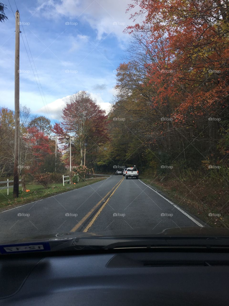 Driving down the road in the fall with colorful foliage