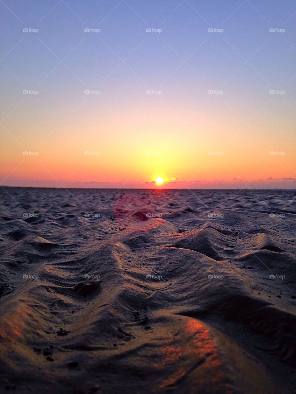 Scenics view of sand at sunset