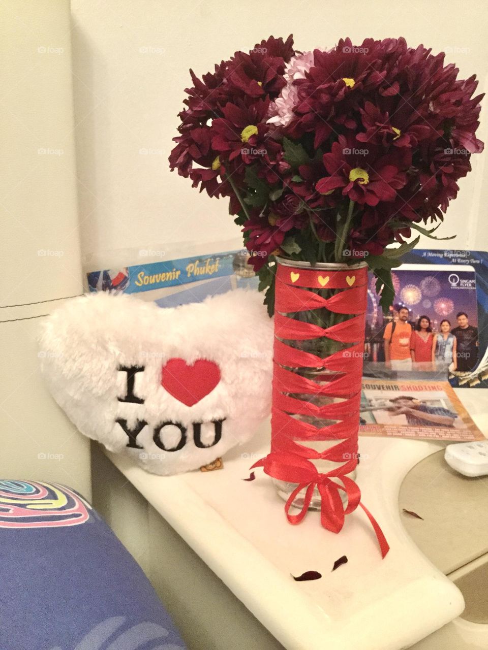 A badminton cock box turned into a beautiful flower vase made with red ribbon by own hands.