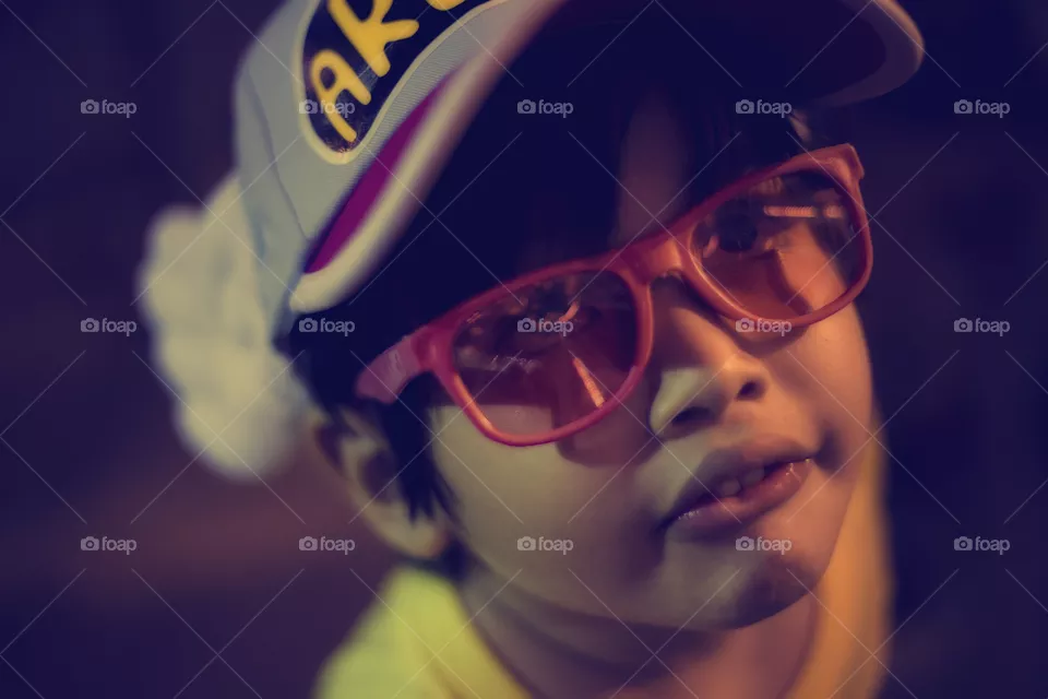 cute boy in style wearing pink sunglasses
