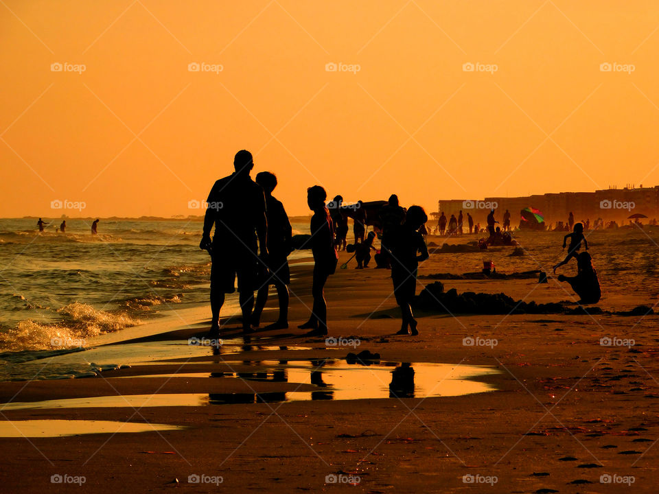 amazing silhouette of people on the beach