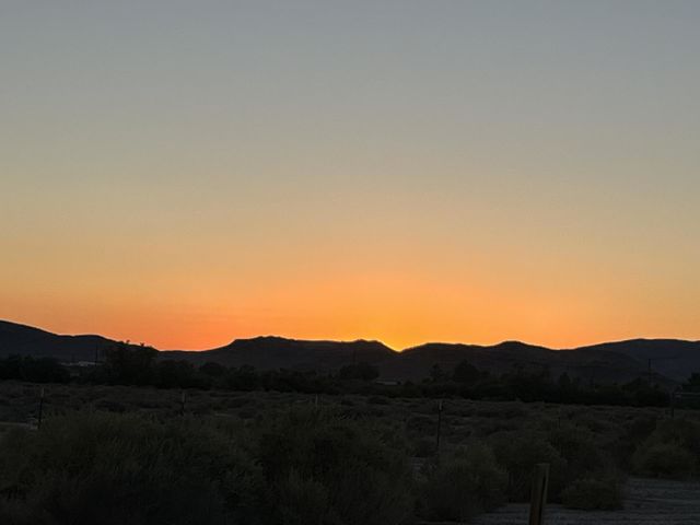 A bright orange sunset with mountains