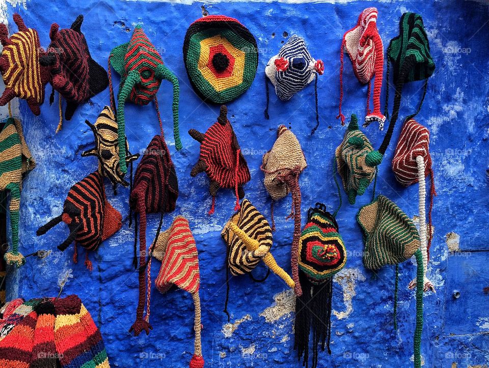 Knitted hats hanging on wall