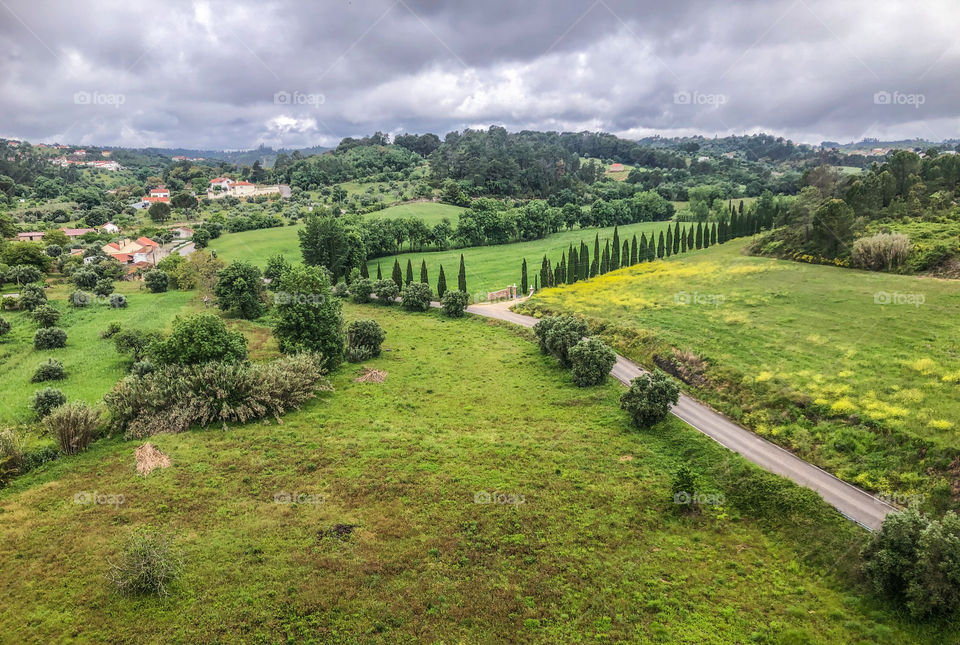 A very green, spring landscape underneath a cloudy sky