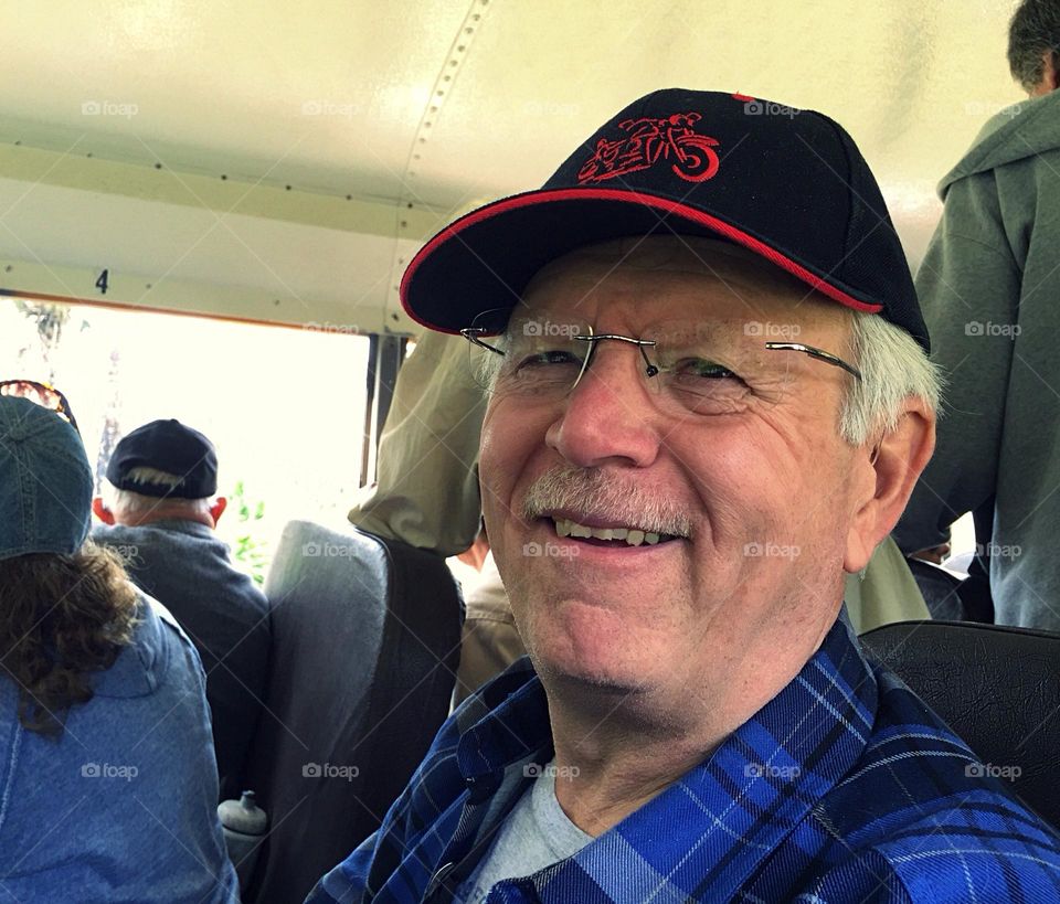 Man in a black hat on a bus.