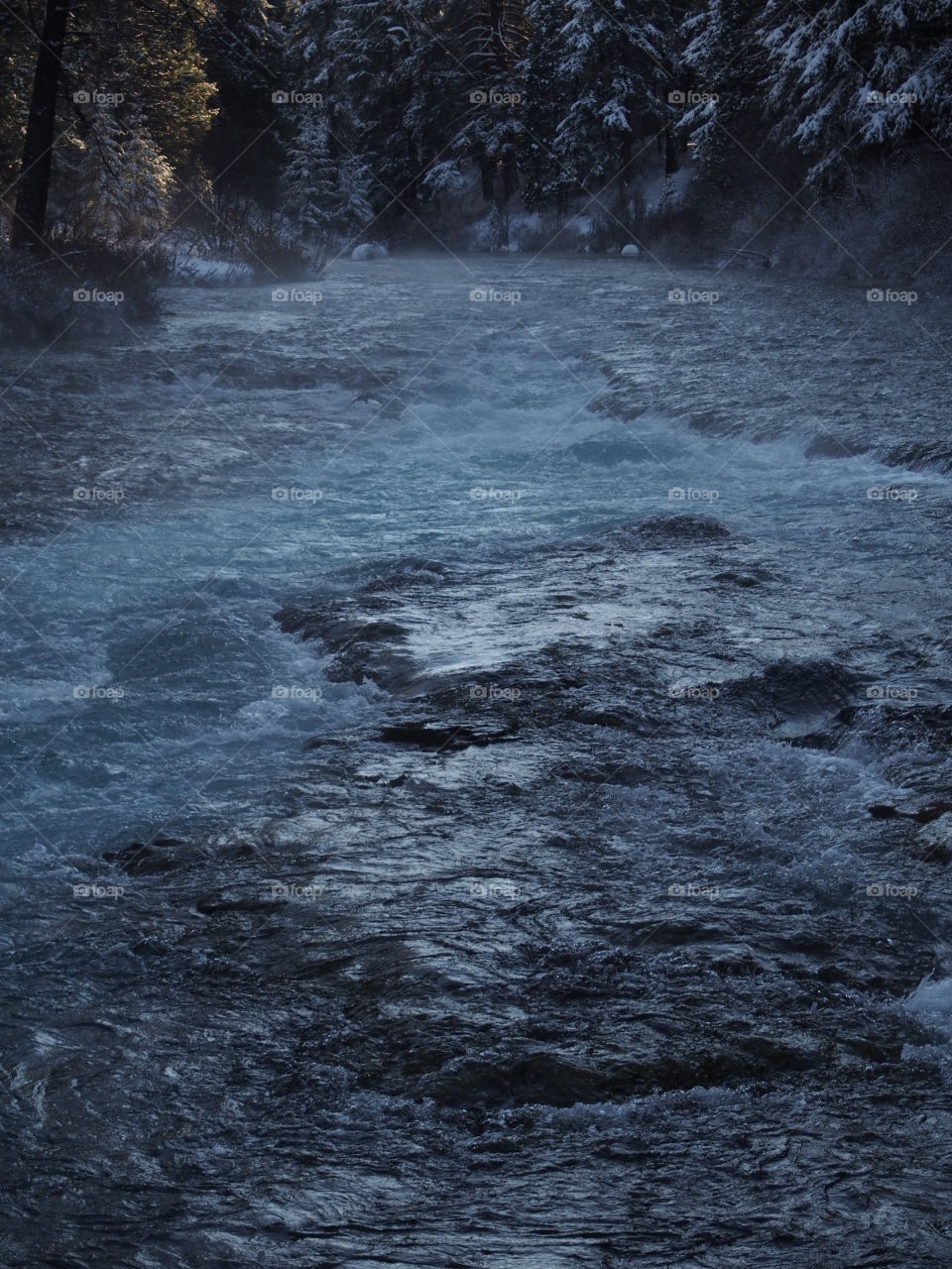 The magnificent Metolius River at Wizard Falls with a morning fog on a cold winter day. 