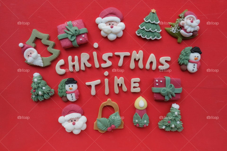 Creative composition of Christmas time with handmade wooden letters and marzipan Christmas symbols