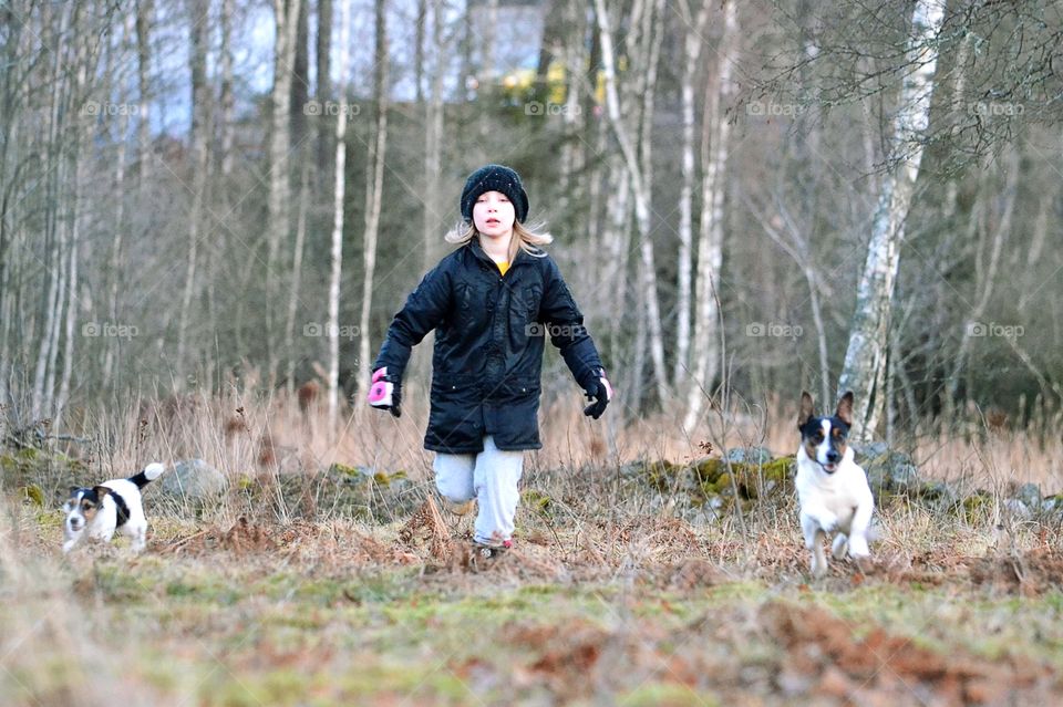 Girl running with dogs