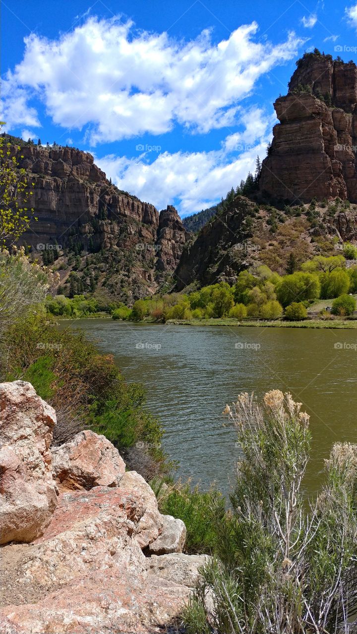 Soaring cliffs of Glenwood Canyon over the tranquil Colorado River.