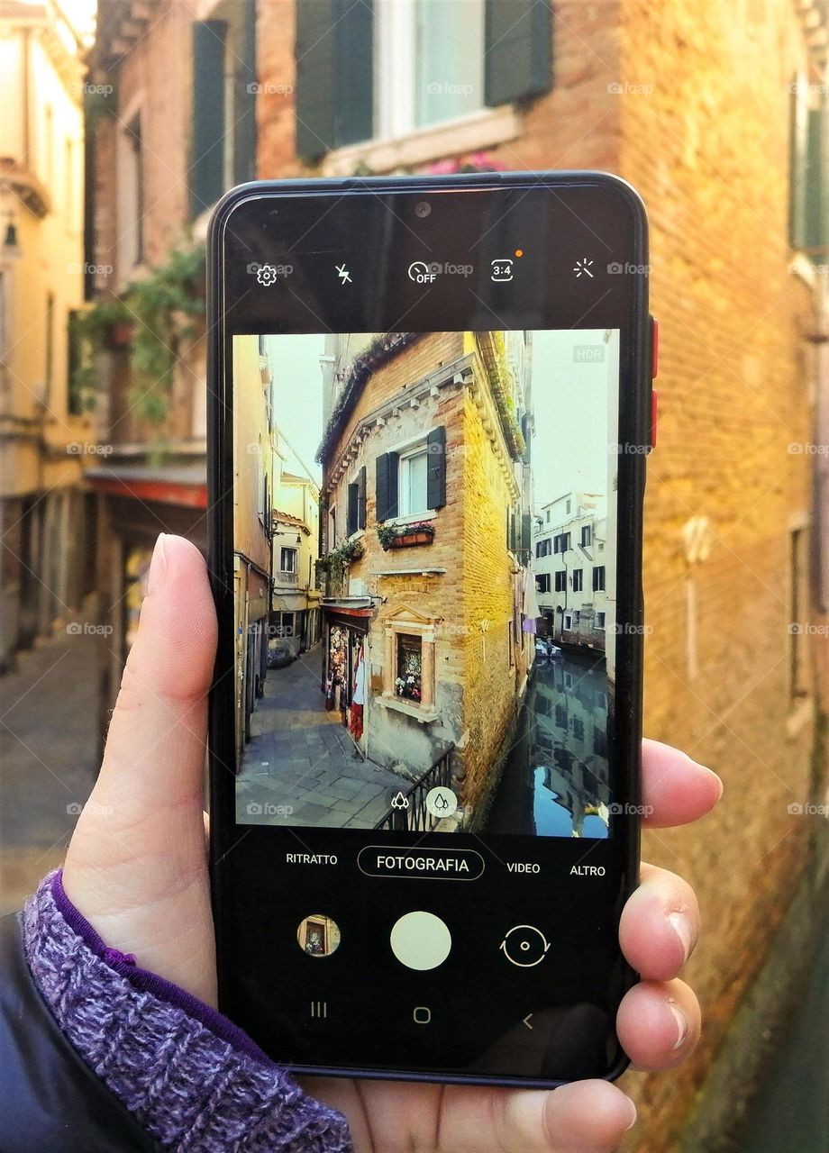 human hand With smartphone, taking photo of Building