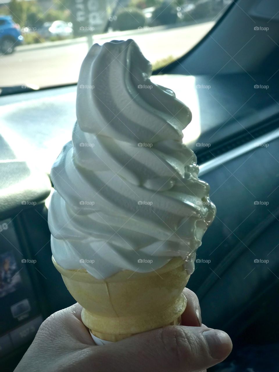 Snacks on the road trip - vanilla ice cream cone in hand 