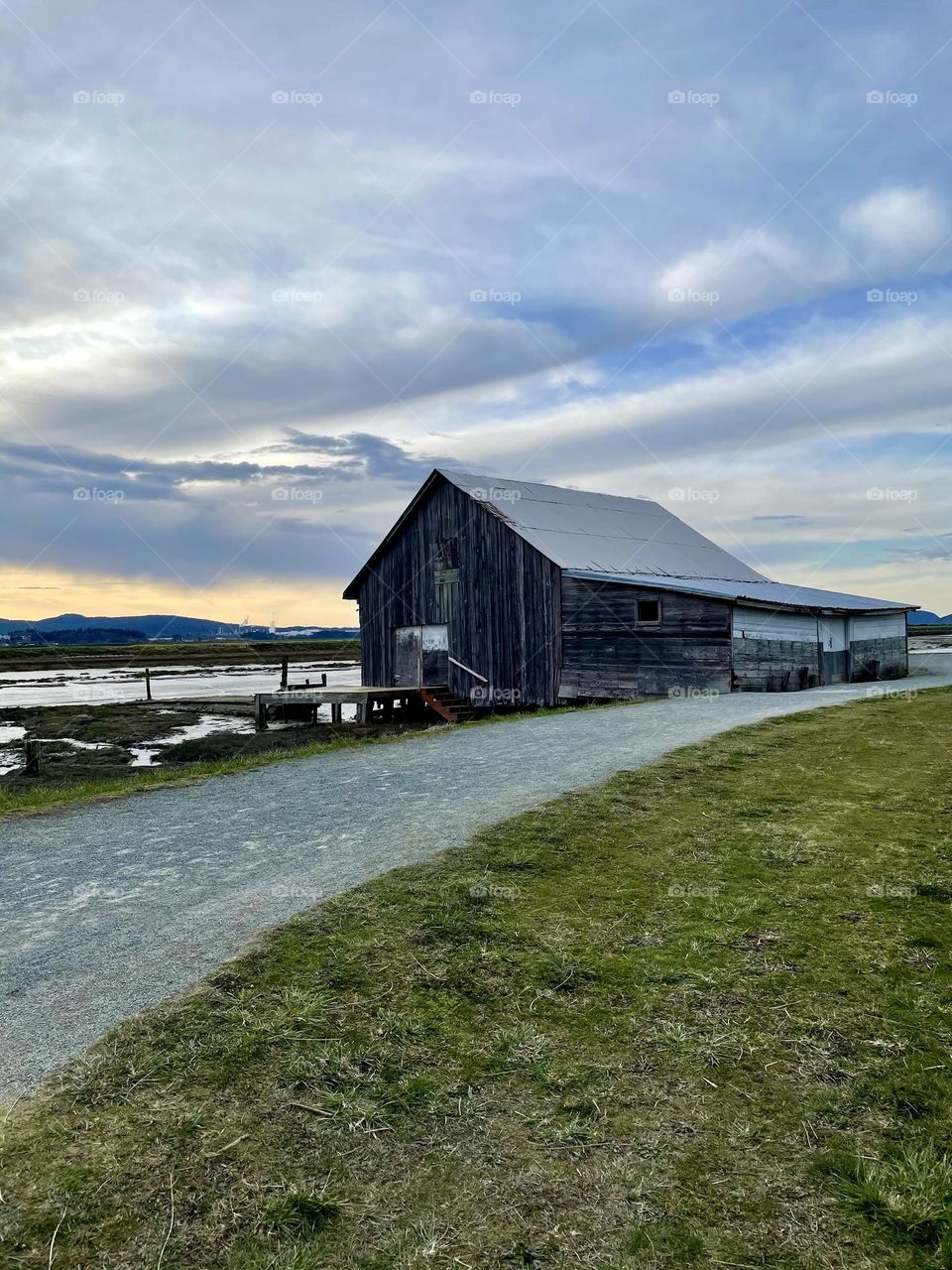 Cloudy view on trail of abandoned barn 