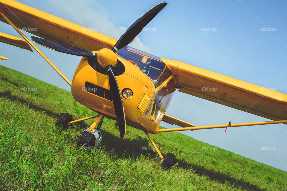 Yellow aircraft on a green grass