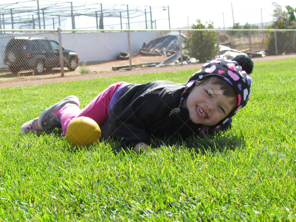 playing ball. rolling in the grass and playing ball