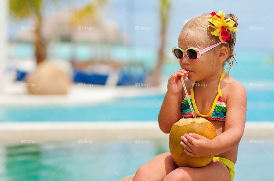 A Kid Drinking Coconut