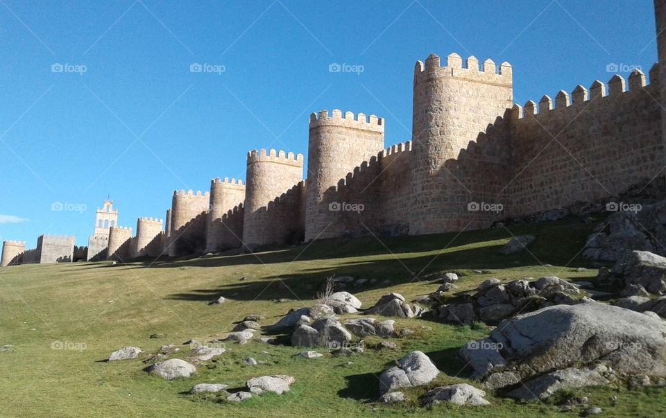 Medieval wall with turrets surrounding the city of Ávila.