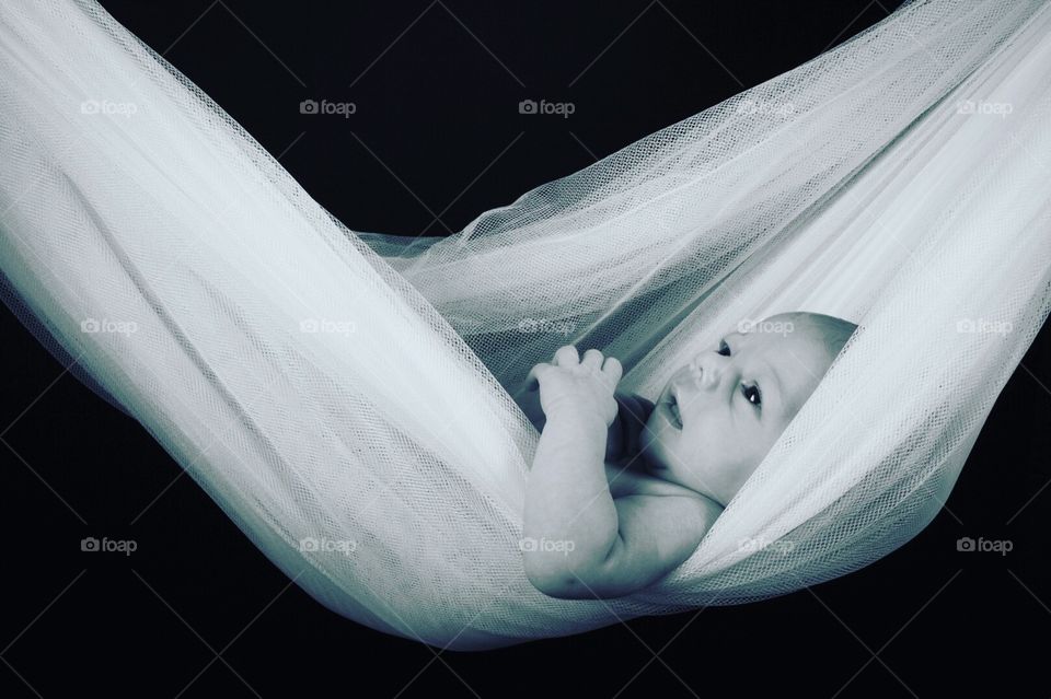 Newborn baby in a net 