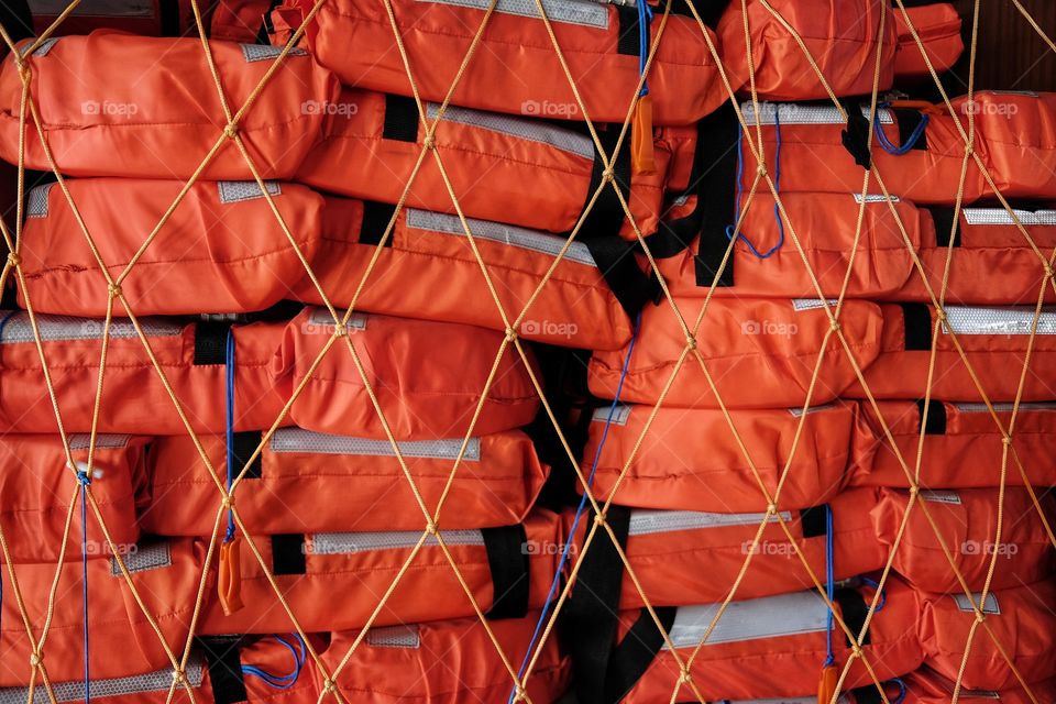 Many stacked lifejackets