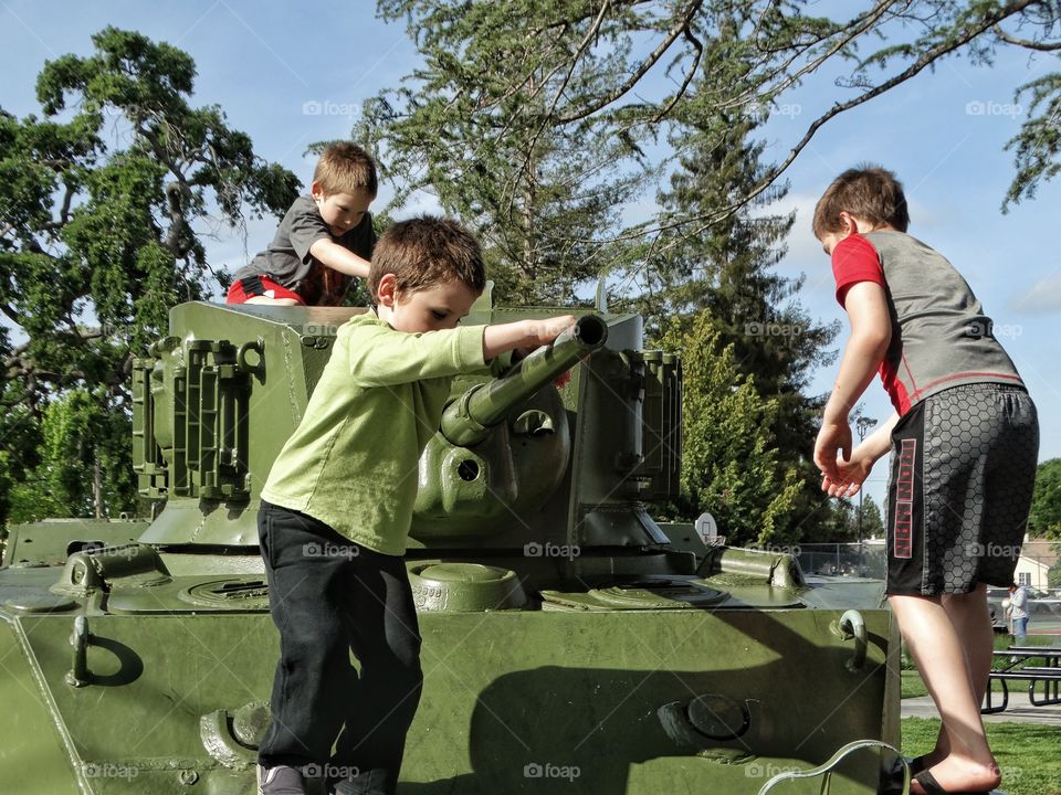 Boys Playing On An Army Tank
