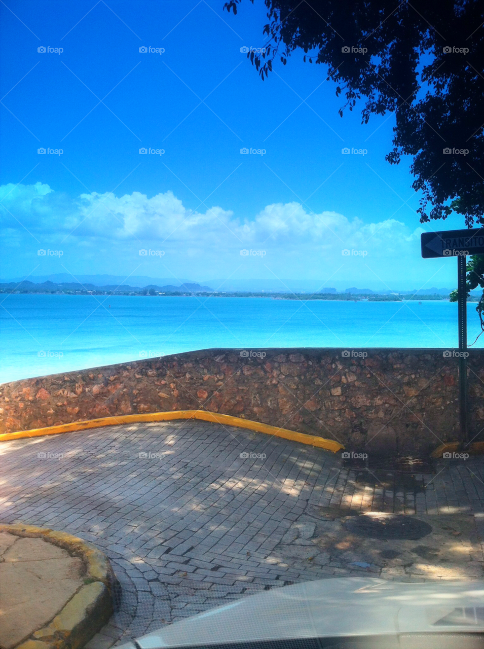 Old San Juan view from historic corner in Puerto Rico. Traveling, walking, photography, instant, blue, skies, cobalt, cobblestone, sidewalk, yellow, ocean, Caribbean, water