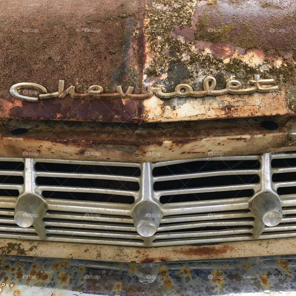 Vintage car rusted with fonts
