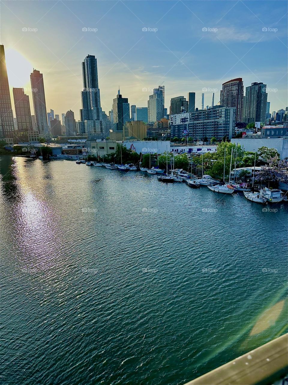 This is “Newtown Creek”, an ocean inlet of the “East River” seen from the “Pulaski Bridge” that connects “Greenpoint”, Bklyn to LIC, Queens. In the distance across the water we see the “Manhattan” skyline. 2024. Hypnotic Productions