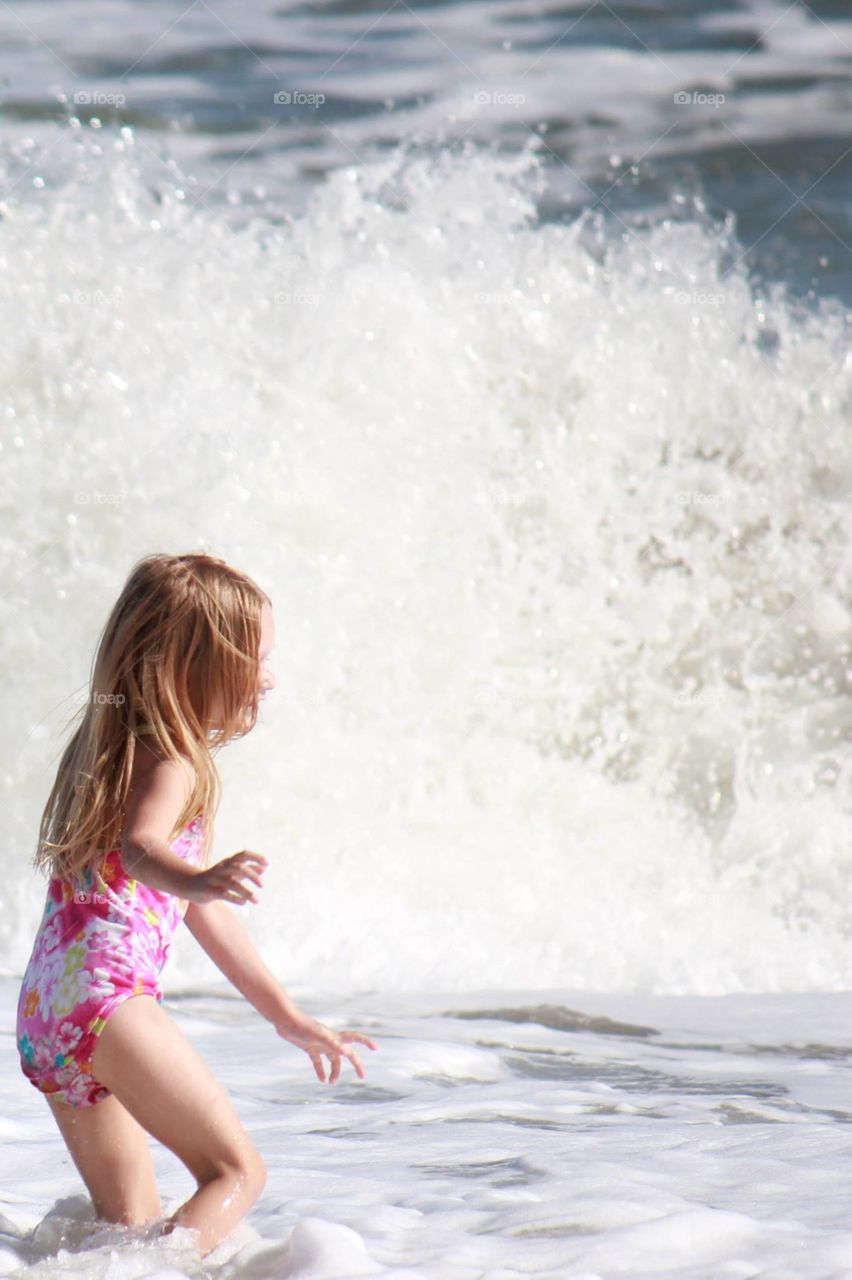 Little girl running at the beach