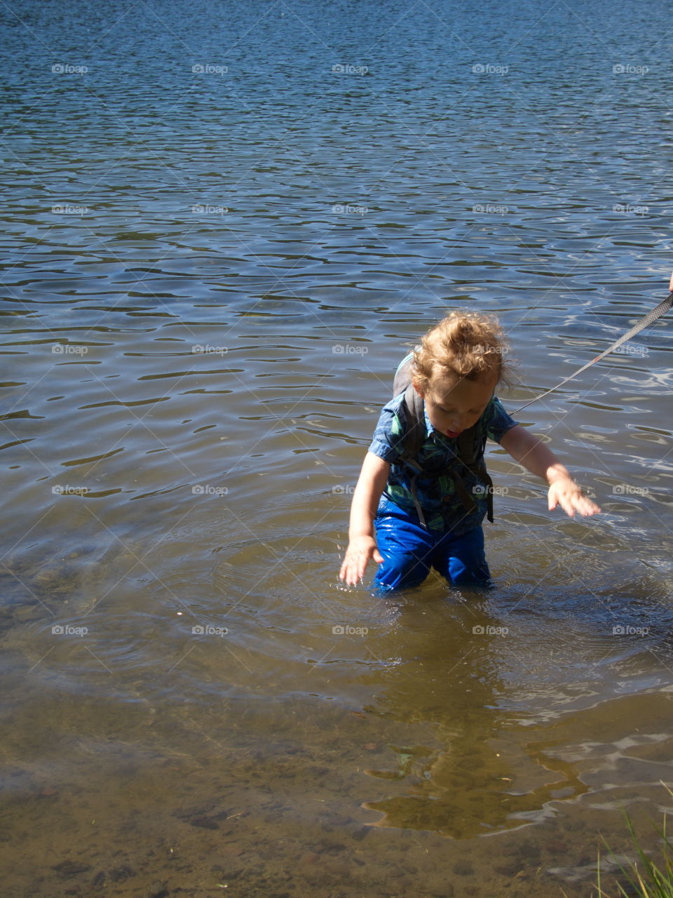 Little boy on summer vacation at high lake in Oregon forest 