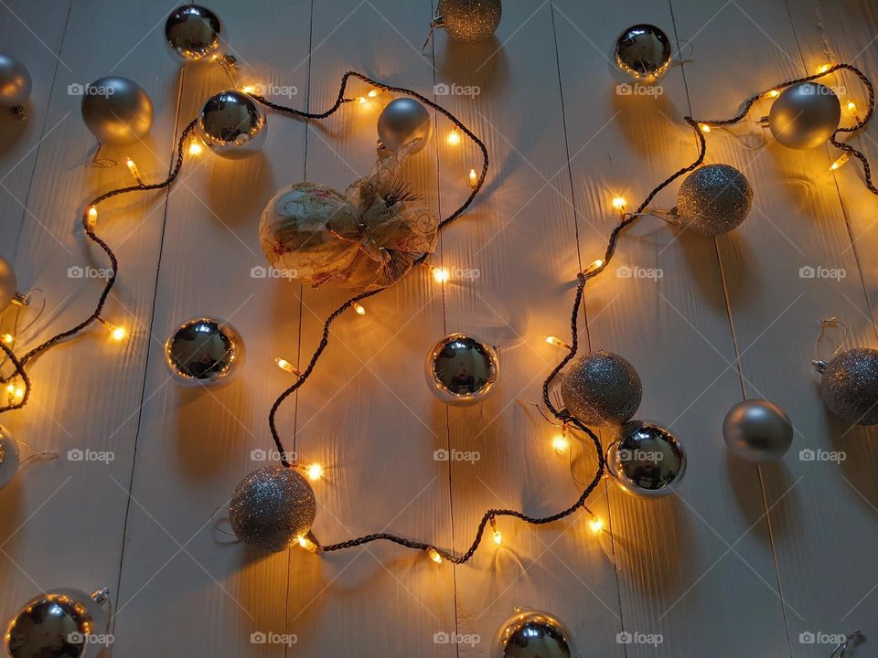 Christmas glowing garland and silver Christmas balls on a white background