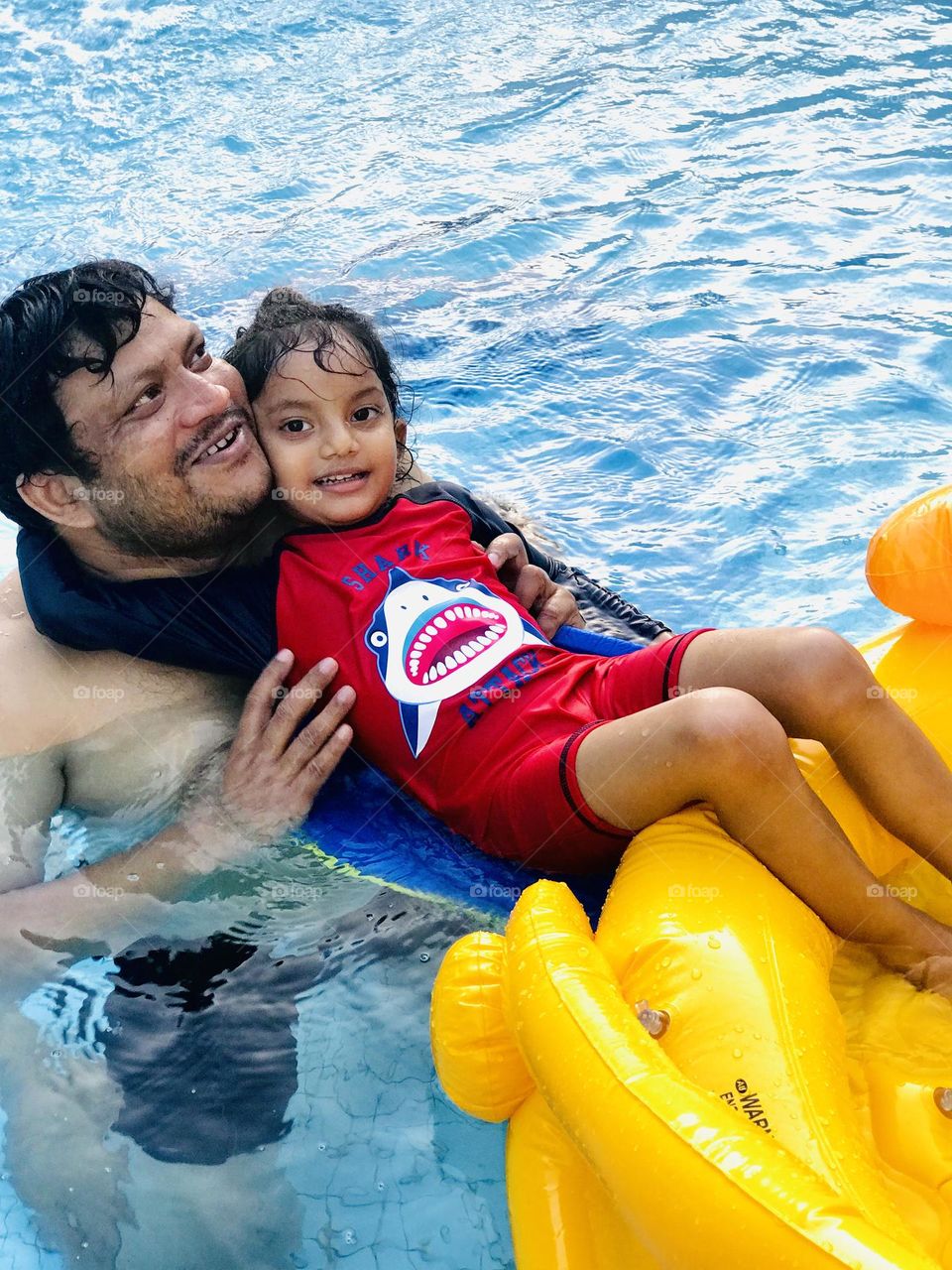 A father and daughter swimming at pool and enjoying a lot 😍