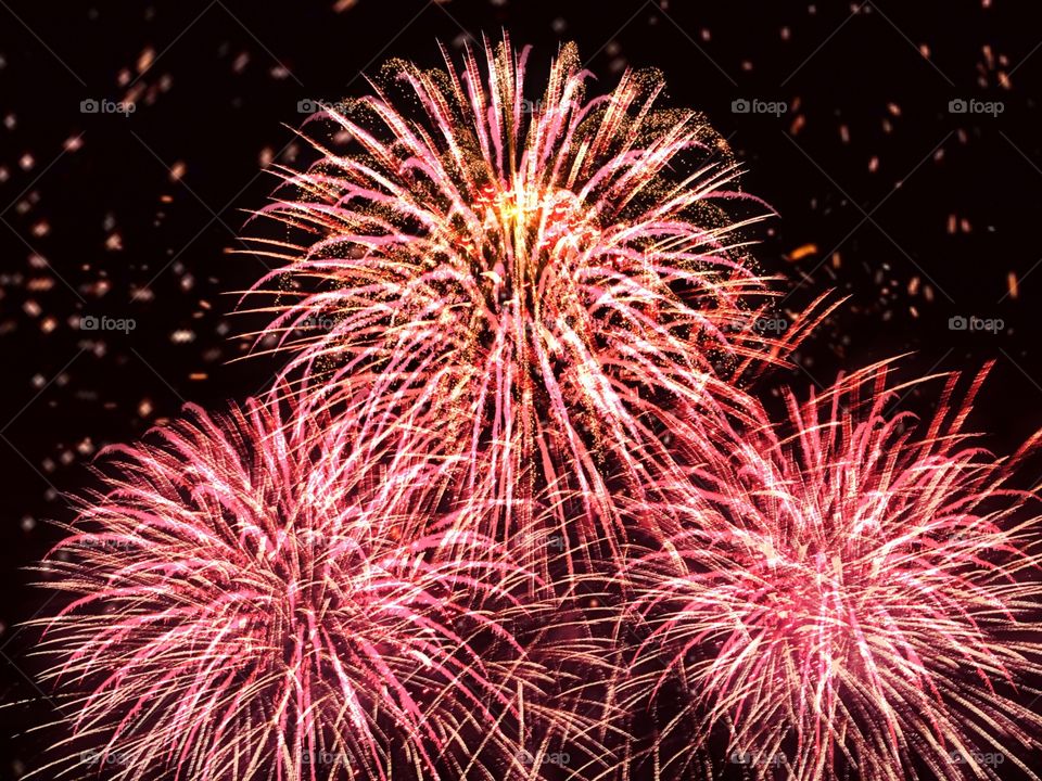 A massive display of red and gold fireworks.