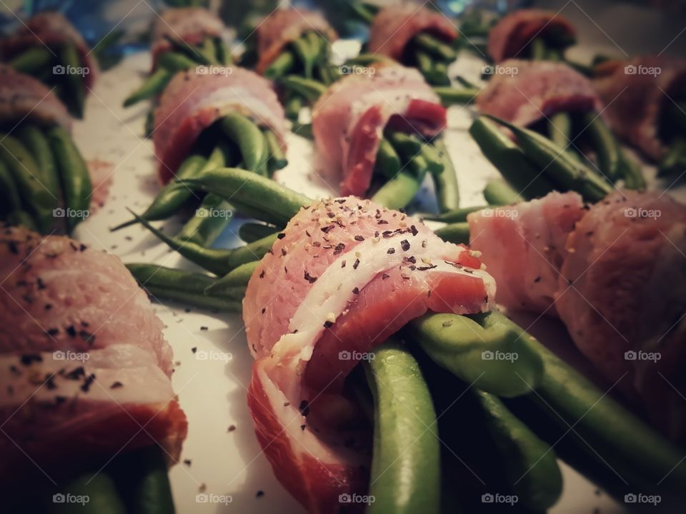 Bacon Wrapped Green Beans with Salt and Pepper Closeup waiting to be cooked